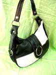 Fine ladies wear catalog company exports Fashionable white and black, checkered purse with thick strap and silver hoop over zippered pocket