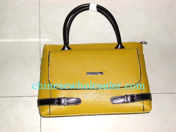 Designer handbag at affordable price distributed by China manufacturing wholesaler. Dark yellow imitation leather purse with brown handles, matching buckle and straps at bottom, and pocket in front to access keys and loose change.    