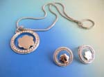 Jewelry distribution wholesaler supplying cz jewelrt gift sets. CZ ring shape frame charm holding a flower suspended on a snake chain, included a matching pair of studs earrings