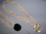 Indonesia wholesale jewellery manufacturer distributes Circle emblem style pendant made from ocean shell on multi string bead necklace 