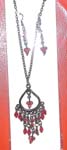 Gemstone jewelry import agent wholesales woomens wear. Ruby red gems dangling on silver plated chain of necklace and earring set