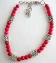Fashion bracelet in multi rounded imitation coral and Celtic silver beads design with lobster claw clasp closure