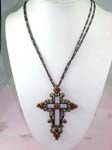 Fashion cross jewelry import distributing business supplying Copper colored fancy cut-out cross necklace with floral design around edges and orange cz stones inlaid, hanging on double string chain
