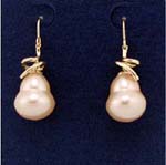 Women wear accessory distributor supplies wholesale faux pearl jewelry. Large imitation mother of pearl earings held by curved, faux gold plated poles