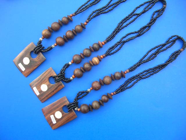 Indonesian, square wooden pendant with sea shell crest on multi string bead necklace - Handcrafted jewelry supplier