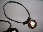 Costume jewelry style pendant with art work painted seashell design black cord necklace with coiled bead wrap around  from import exchange supply dealer