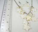 Fashion seashell earrings in star design paired with silver plated necklace holding multi star-shaped seashell at center 