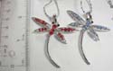 Fashion necklace with silver plated chain, holding dragonfly pendant with multi cz stone embedded on the body and wings