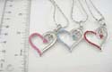 Fashion silver plated necklace holding cut-out heart shape pendant with mini cz stone embedded on one side. Lobster claw clasp