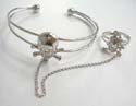 Fashion slave bangle bracelet-ring in carved-out double band design with a skull decor at center 